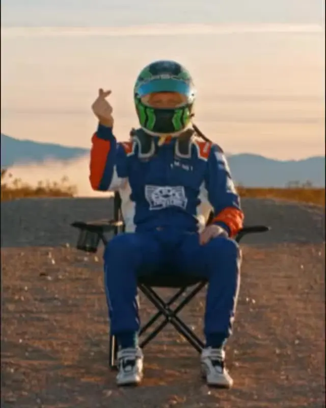 Filip Ugran in race suit and helmet on a folding chair, Instagram reel “My way.”