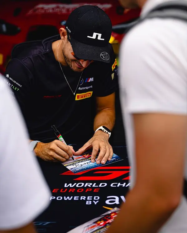 Paradine Competition driver signing autograph cards at GT World Challenge Europe Valencia